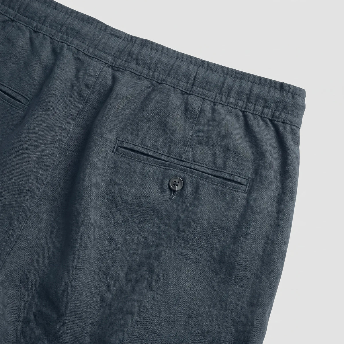 Rear view of light blue linen shorts showing the back seam and relaxed fit