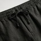 Khaki linen shorts shown from above, displaying the full silhouette and leg openings
