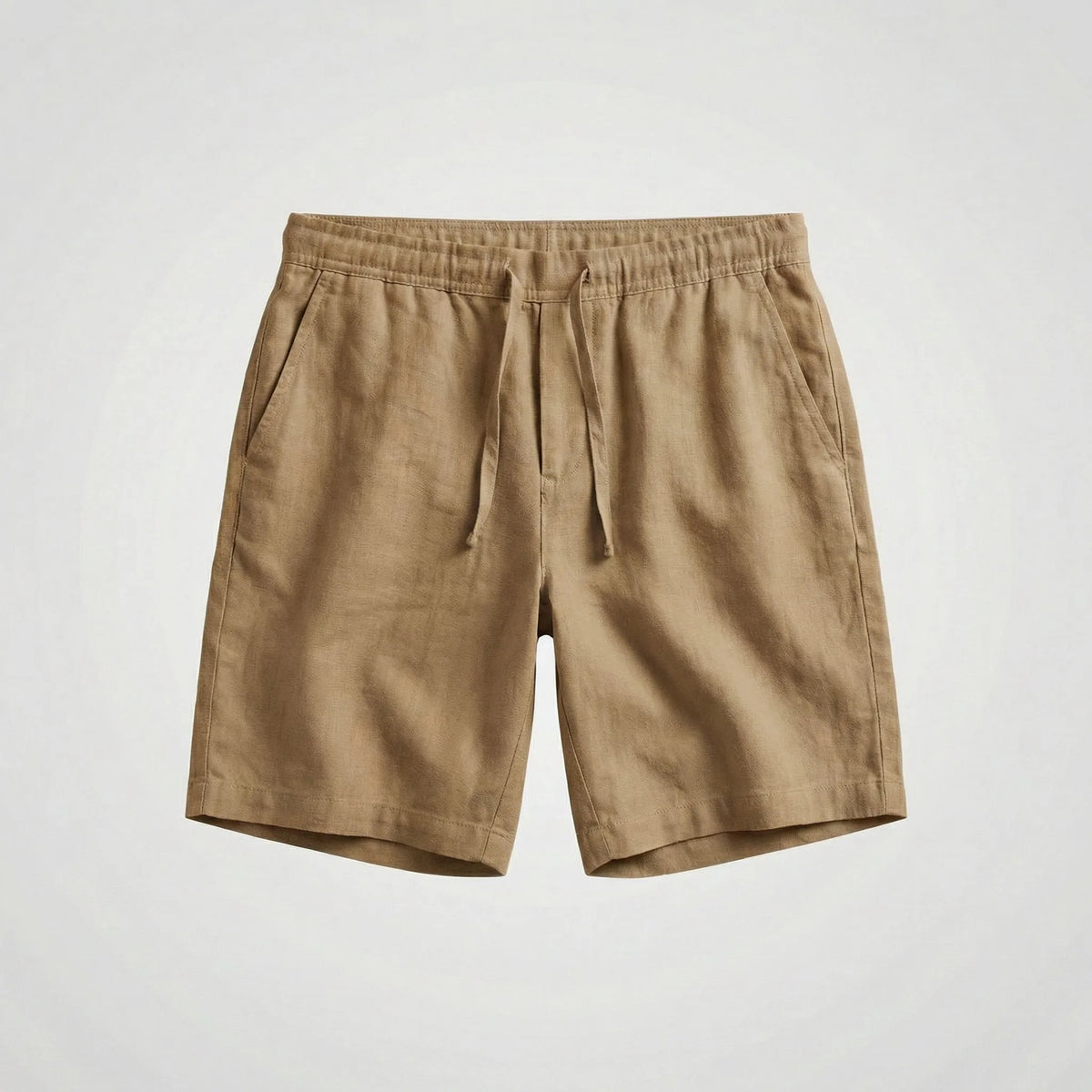Khaki linen shorts laid flat, showing the relaxed fit and tapered hem