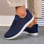 Navy sneaker toe box close-up showing breathable mesh knit construction