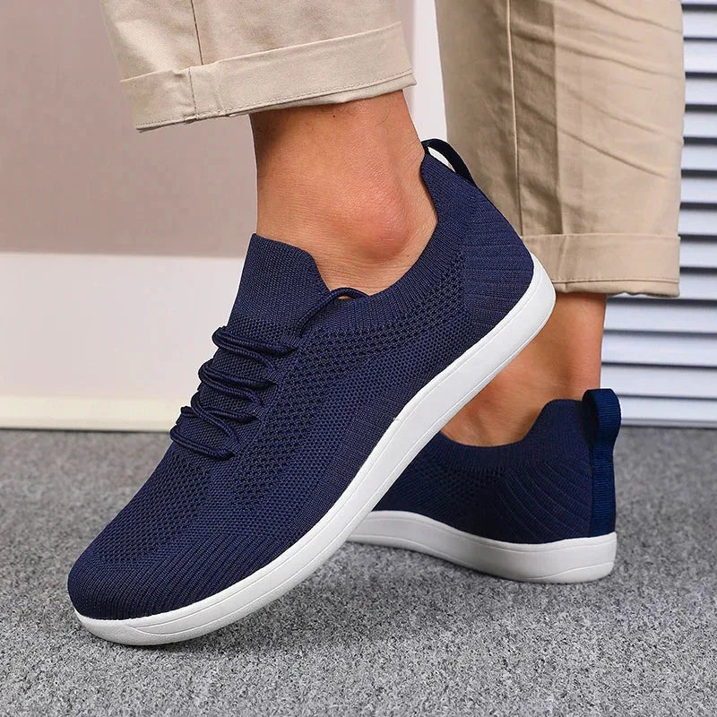 Navy sneaker toe box close-up showing breathable mesh knit construction