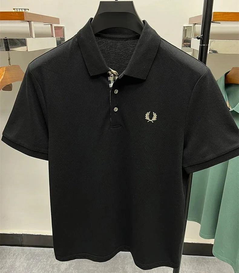 Collar and placket detail shot showing the pique knit texture and embroidered emblem on a hanging polo