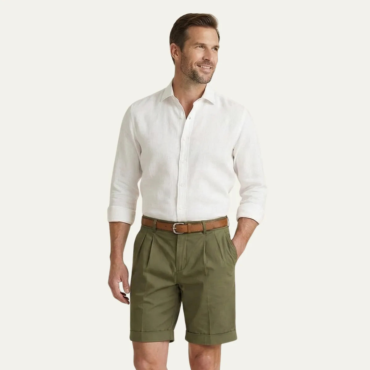 Man standing outdoors showing the fit and length of the pleated chino shorts with turn-up cuffs