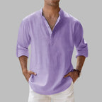 Purple linen shirt with notch collar and button placket, long sleeves rolled to the forearm