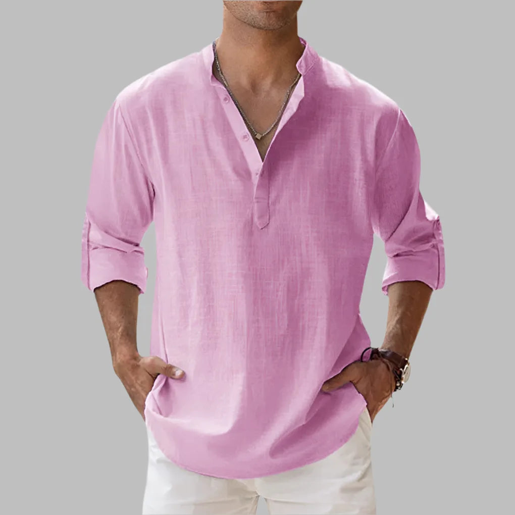 Pink linen shirt with buttoned stand collar and relaxed silhouette, sleeves rolled up casually