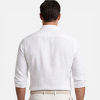 Rear view of white linen cotton shirt showing slim fit through the back and rolled sleeves