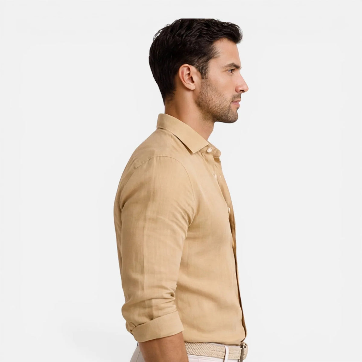 Side profile of beige shirt showing slim fit through torso and rolled sleeve