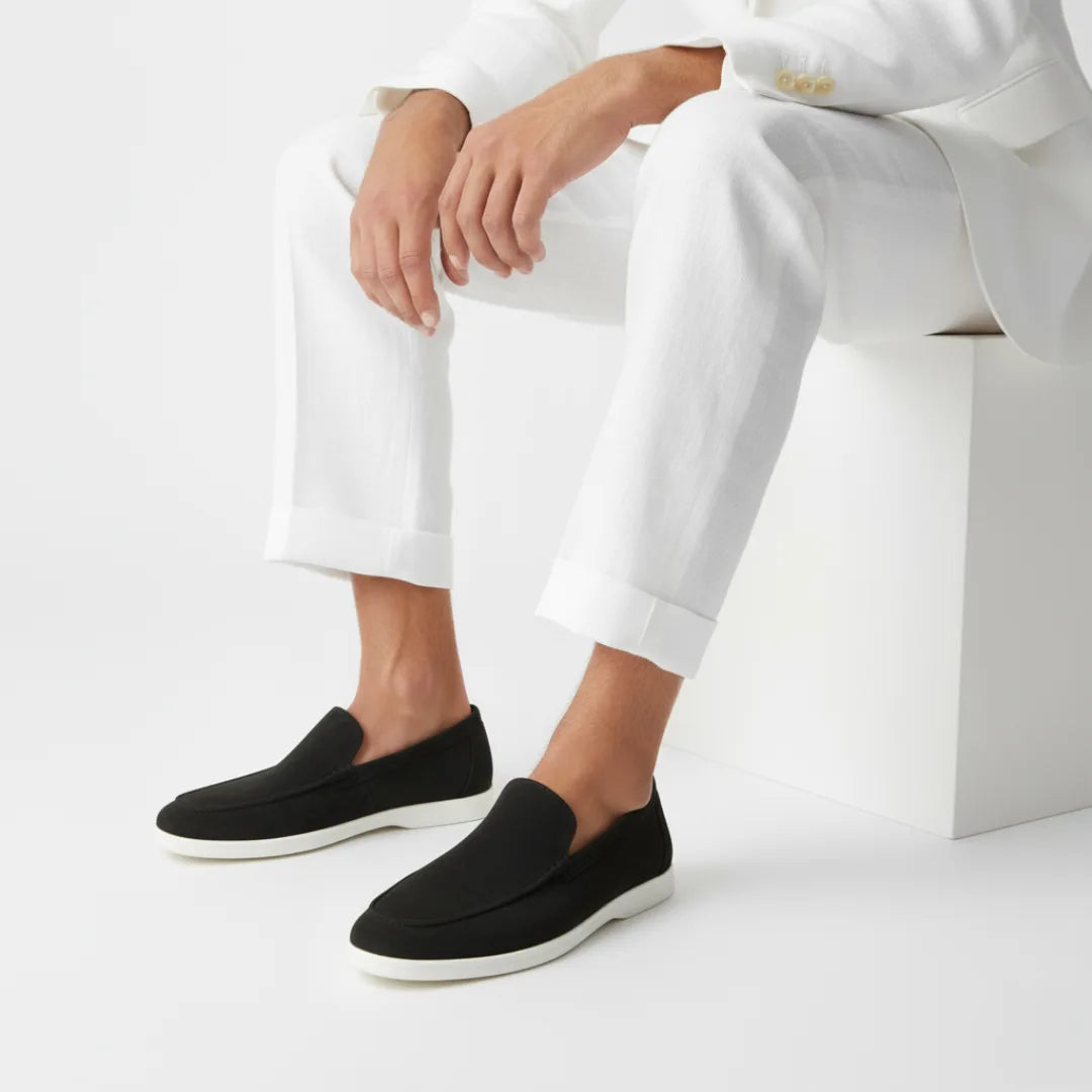 Side profile of a caramel-toned suede loafer with visible apron stitching and a slip-on entry