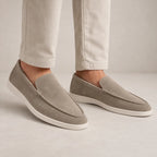 Three-quarter view of navy suede loafer highlighting smooth suede texture and white outsole