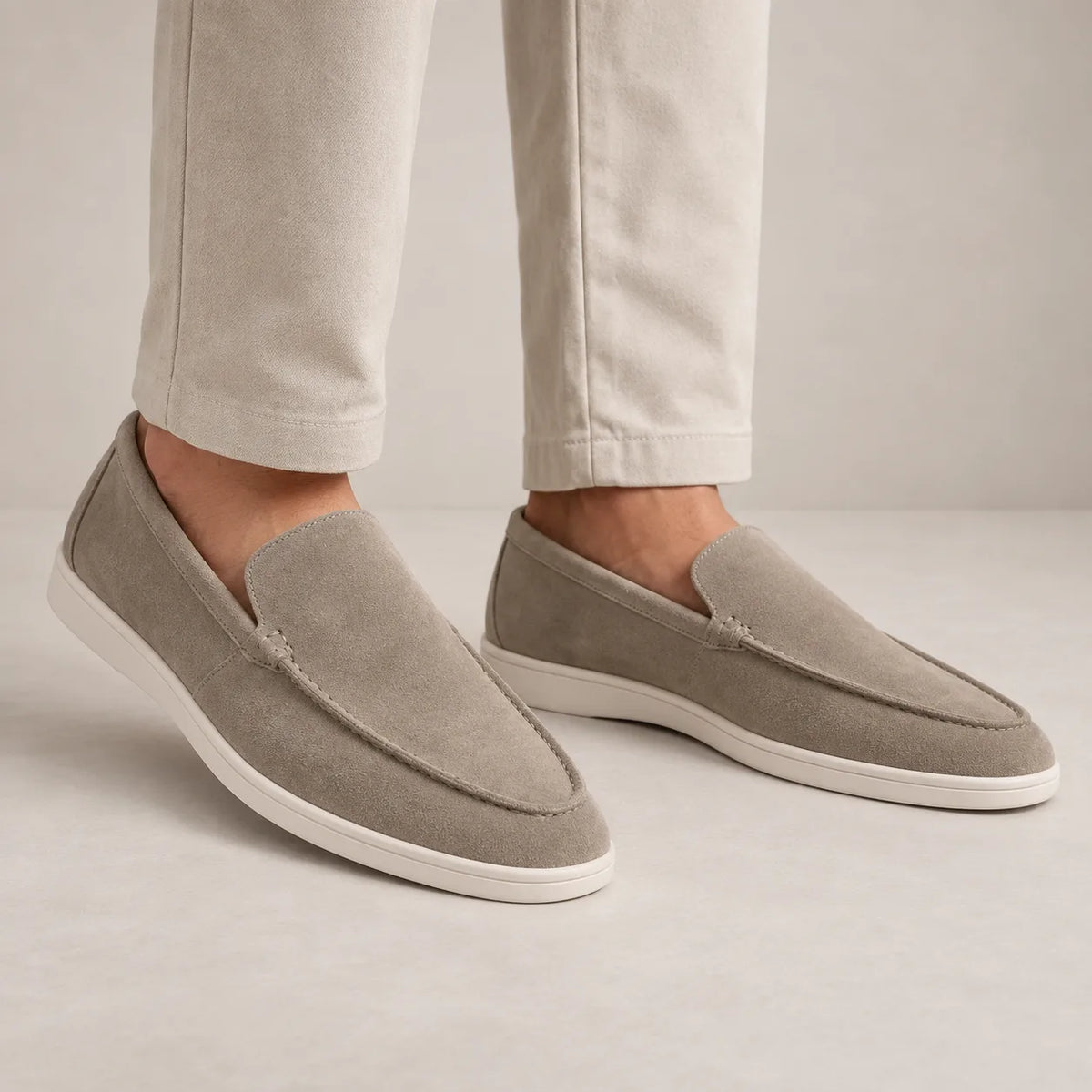 Three-quarter view of navy suede loafer highlighting smooth suede texture and white outsole