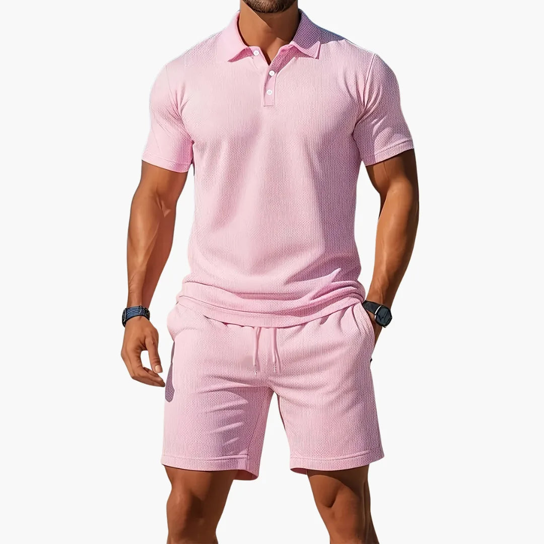 Model showing the matching shorts with side pockets and adjustable drawstring waistband paired with the polo.