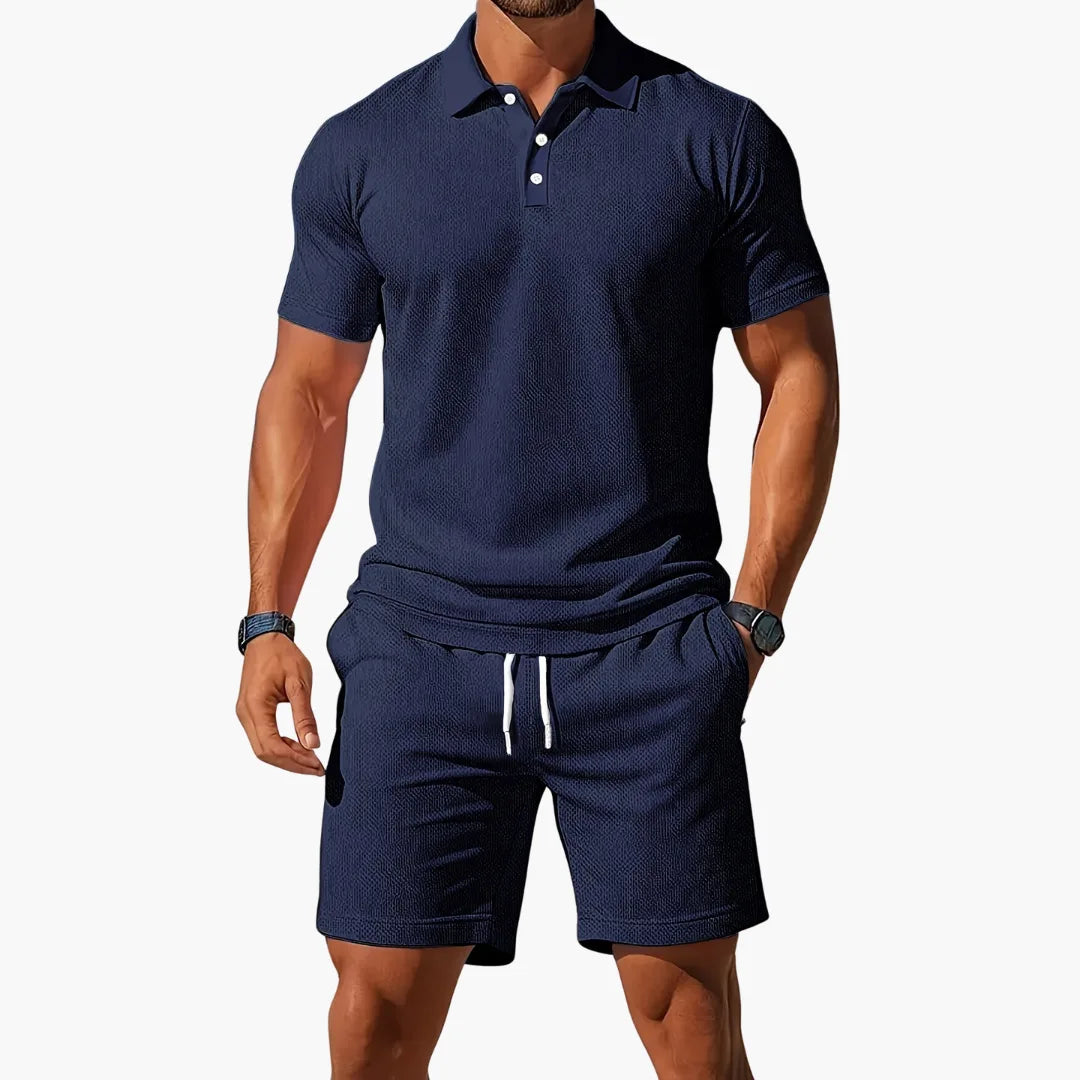 Navy blue textured polo shirt paired with coordinating navy shorts, buttoned collar detail visible on model.