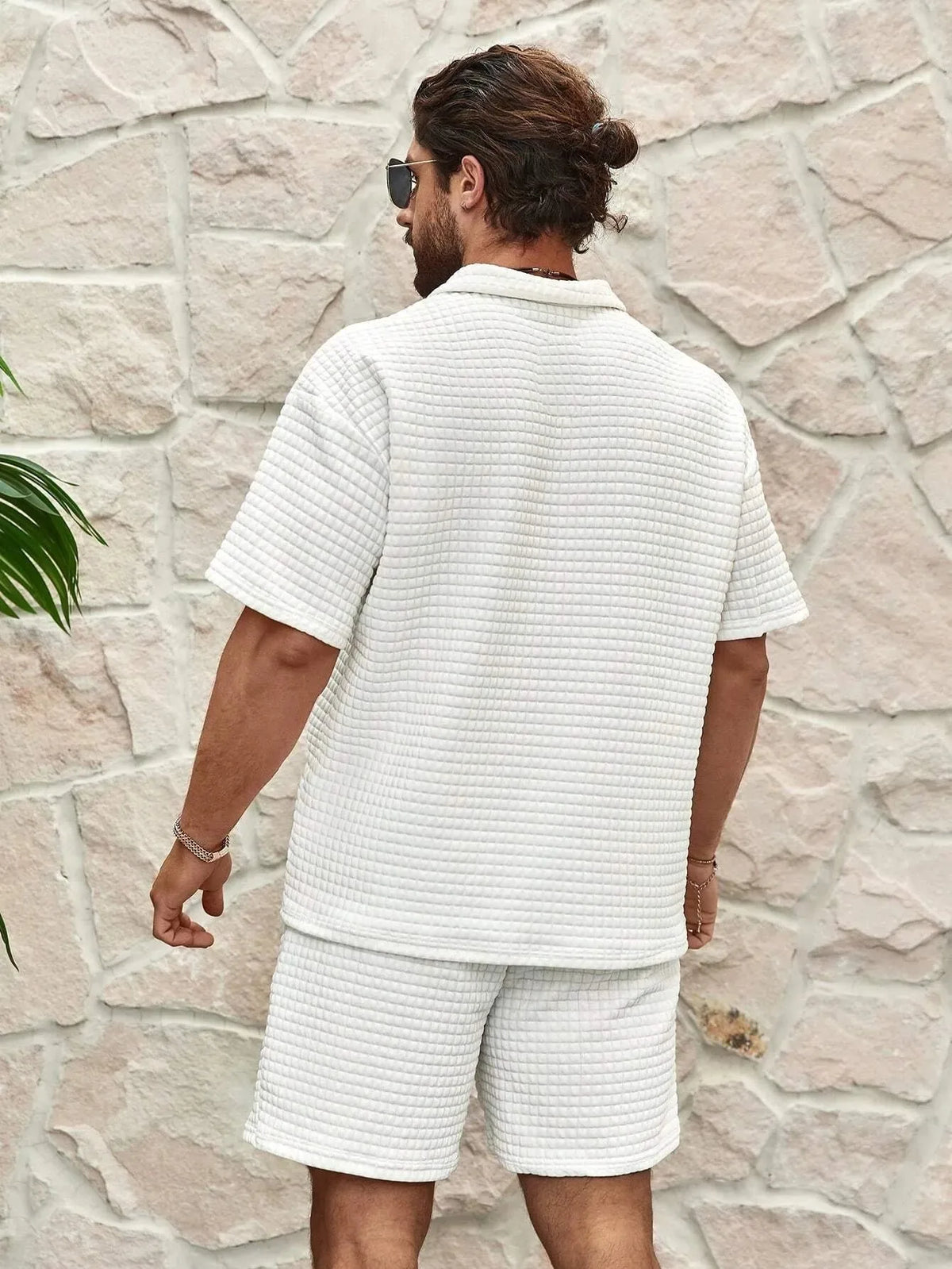 Back view of a white textured polo and shorts set showing the relaxed fit through the shoulders and back