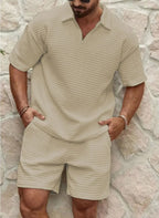 Man wearing a beige textured two-piece polo and shorts set with hands tucked into the shorts pockets