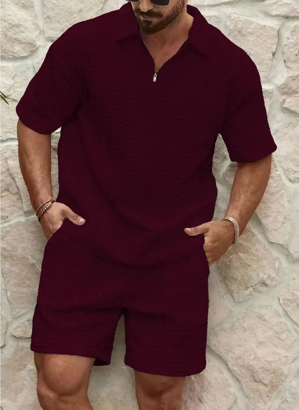 Front view of a burgundy textured quarter-zip polo shirt paired with matching tailored shorts