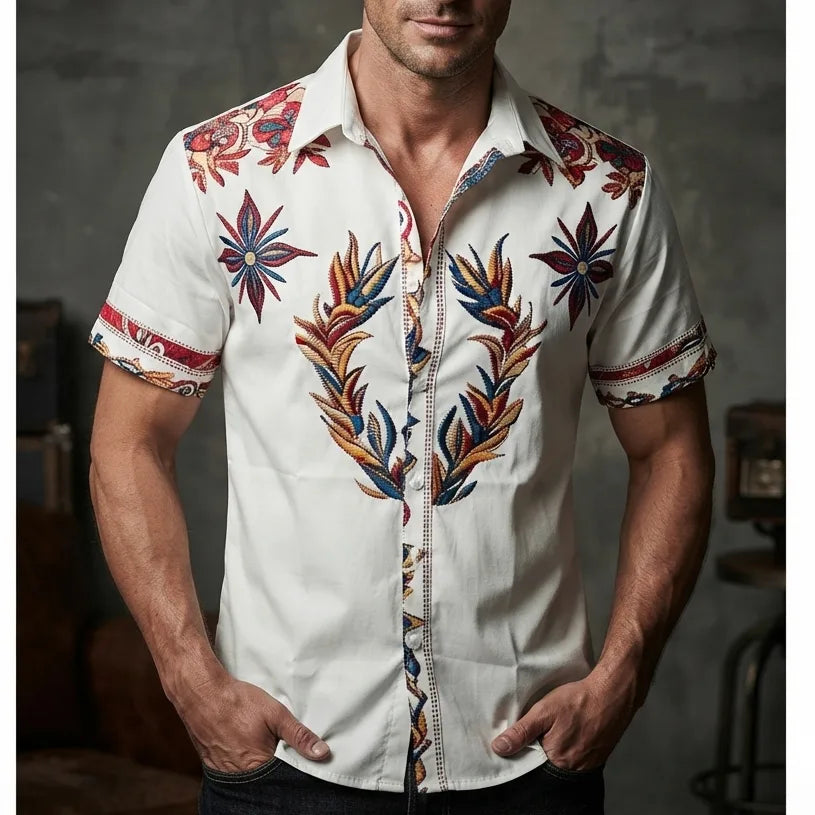 Close-up front view of a white short-sleeve shirt with bold red, navy and gold western floral embroidery down the placket
