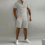 Light grey zip-collar polo and matching shorts outfit shown on a male model against a plain backdrop