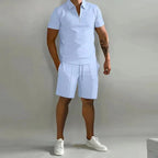 Pale blue short-sleeve polo paired with matching tailored shorts and white sneakers, full-length front shot