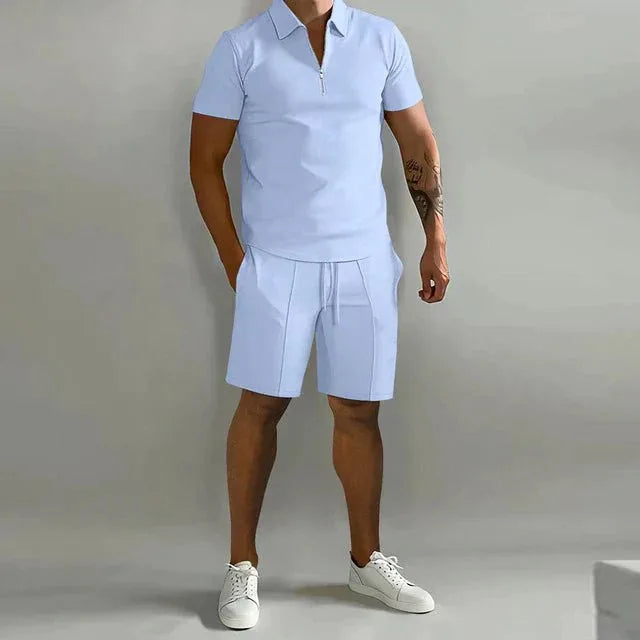 Pale blue short-sleeve polo paired with matching tailored shorts and white sneakers, full-length front shot
