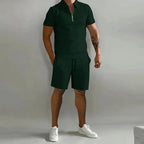 Dark green short-sleeve zip polo paired with matching tailored shorts and white sneakers