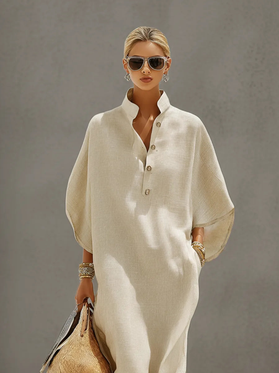 Close-up front view showing the mandarin collar, button neckline and loose dolman sleeve of the oatmeal linen dress