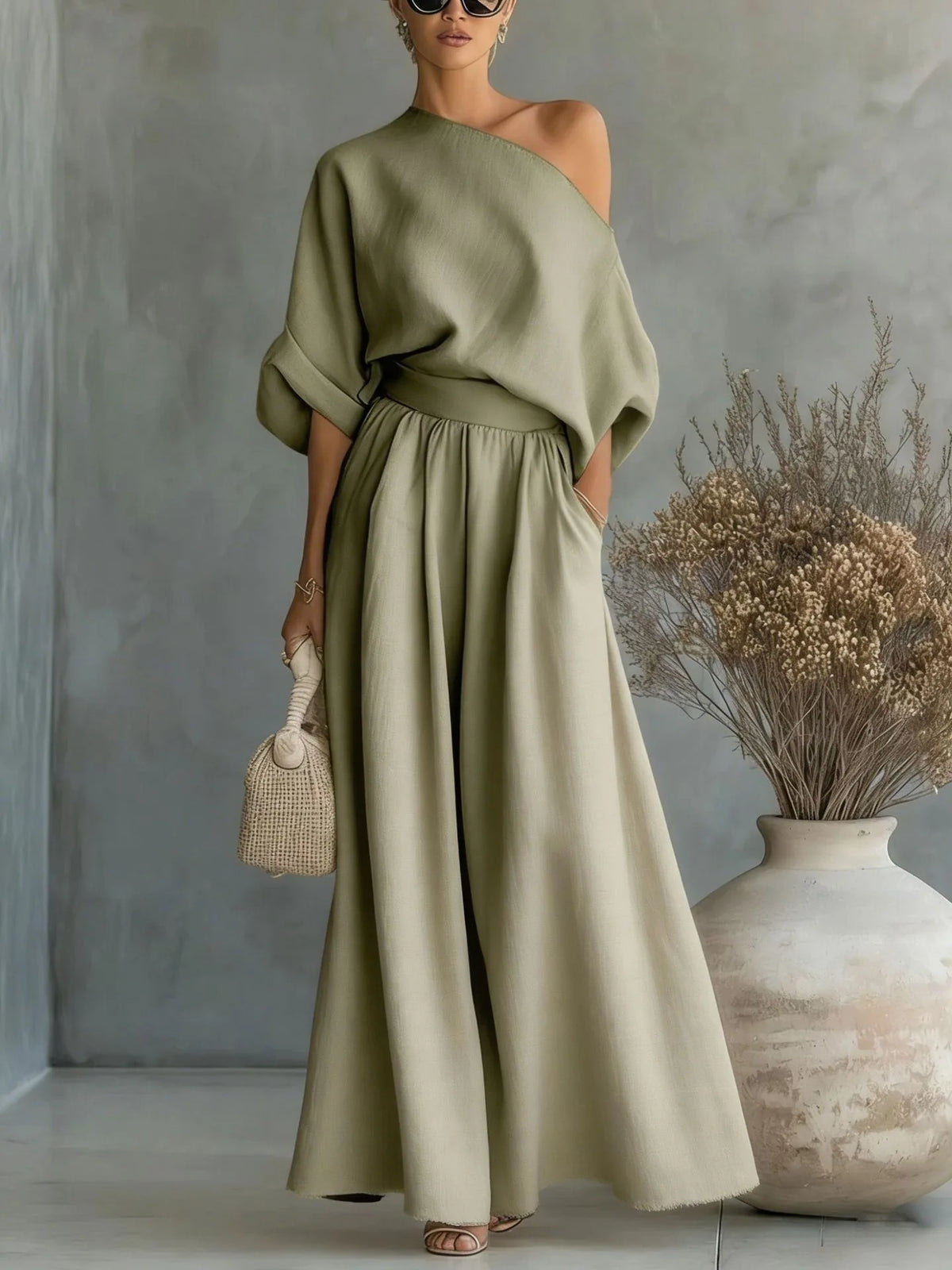 Full-length view of the black two-piece set showing the hand resting in the hidden side pocket of the skirt