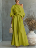 Styling shot of the maxi set paired with a woven top-handle bag and strappy heeled sandals