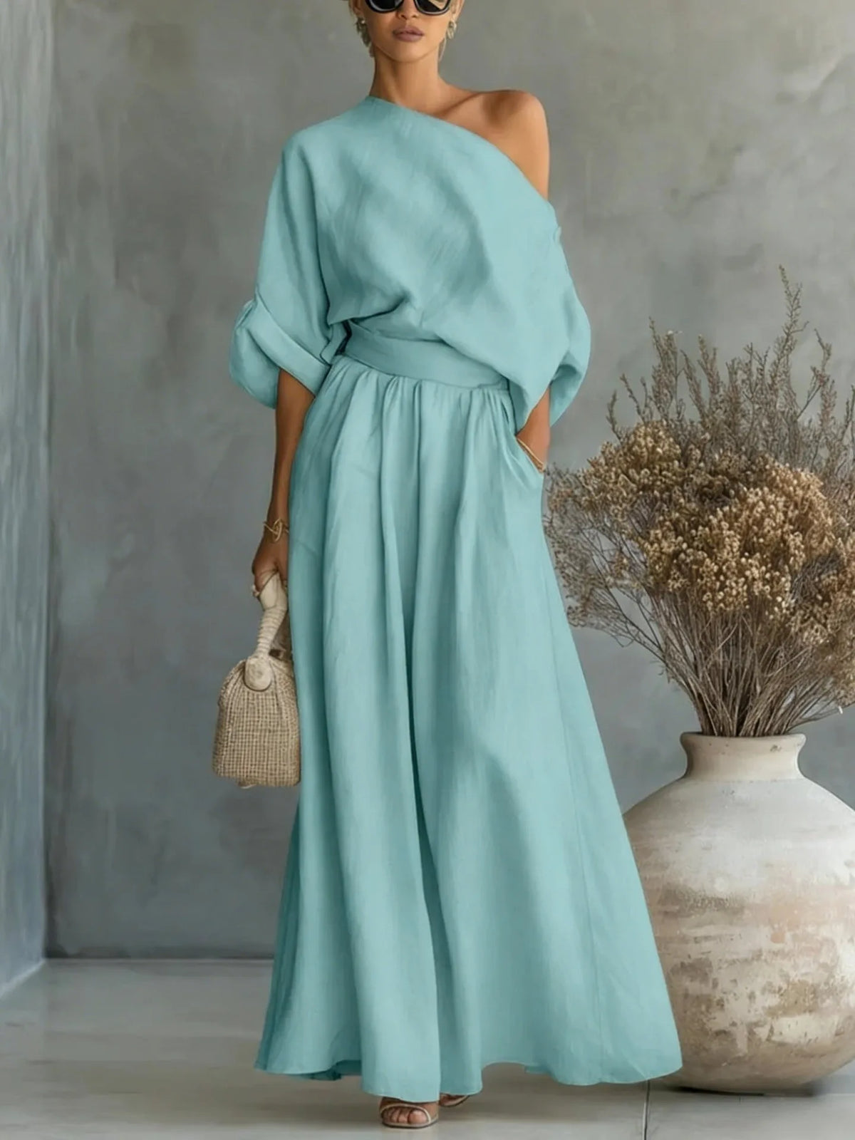 Close-up of the fabric texture and drape of the wide-leg maxi skirt in black