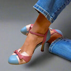 Close-up of colourblock heels in powder blue, dusty pink and nude leather with a bow detail, worn with cuffed jeans.
