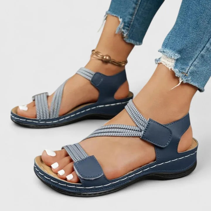 Front view of khaki sandal pair worn showing open toe and multi strap design