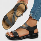 Pink sandal pair on feet from front showing matching crisscross strap pattern