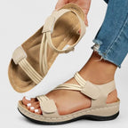 Blue woven strap sandal pair worn on feet showing textured ankle strap and open toe