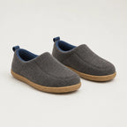 Pair of charcoal grey felt slip-on slippers with navy blue fleece lining and tan rubber soles