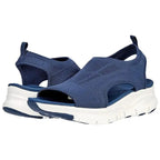 Pair of navy blue knit slip-on sandals with chunky white platform sole and cut-out side detail