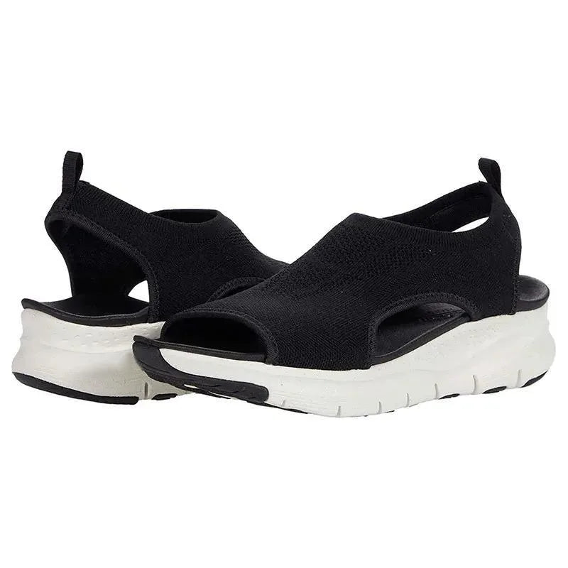 Black knit slip-on sandals shown together, open toe and sling-back heel with white ridged outsole