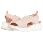 Blush pink knit sandals with shaped footbed and thick white wedge sole, side cut-out visible