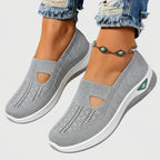 Light grey knitted slip-on sneakers with perforated texture, cut-out vamp and white wedge sole, paired with an anklet