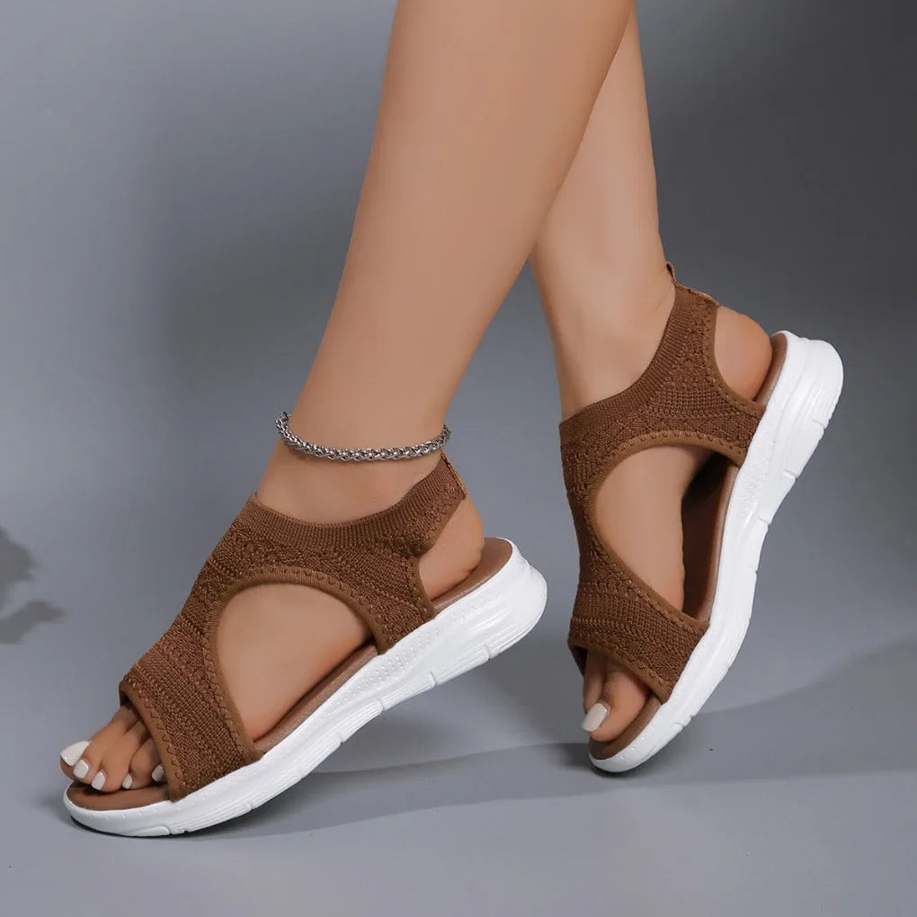 Brown knitted sport sandals with cut-out arch detail, side view showing ribbed sole texture