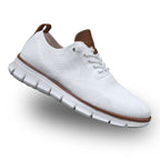 Side profile of a white knit sneaker showing lace-up front and tan leather trim along the heel