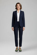 Woman in a navy suit styling the green Mary Jane flats with cropped tailored trousers