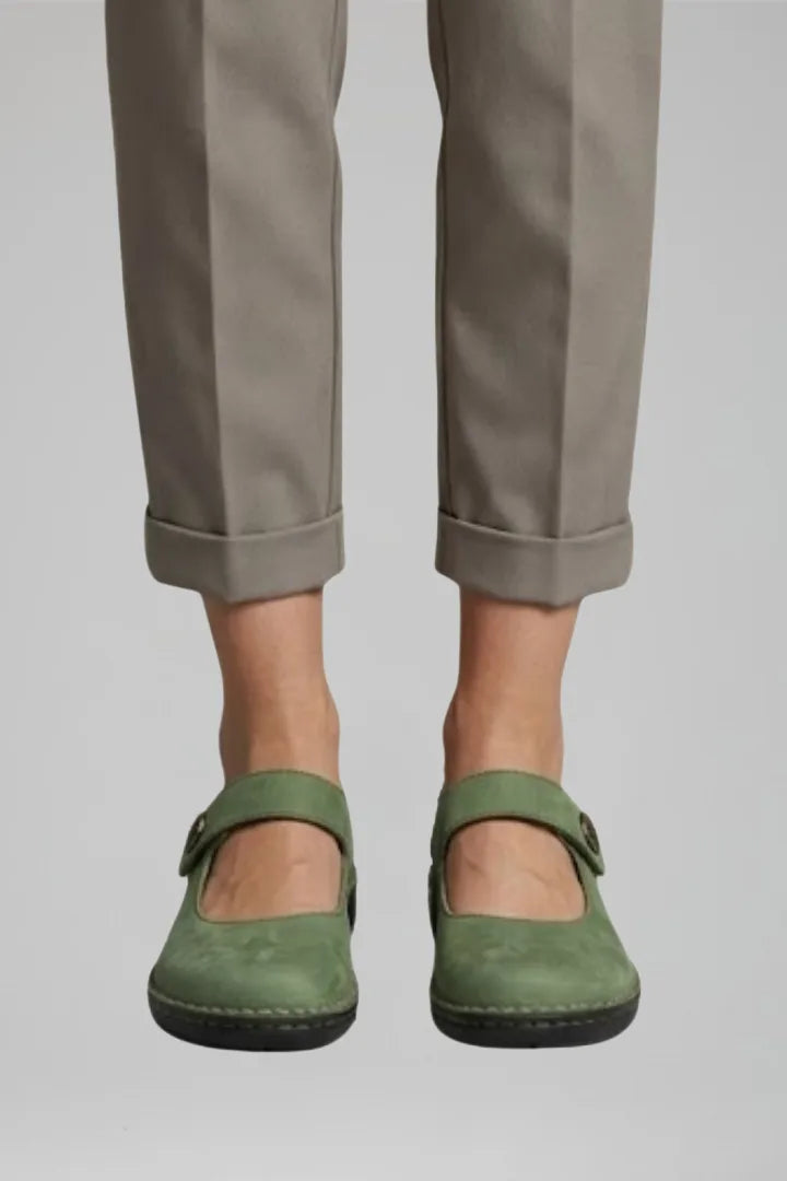 Front view of ankle-length cuffed trousers worn with green nubuck Mary Jane flats