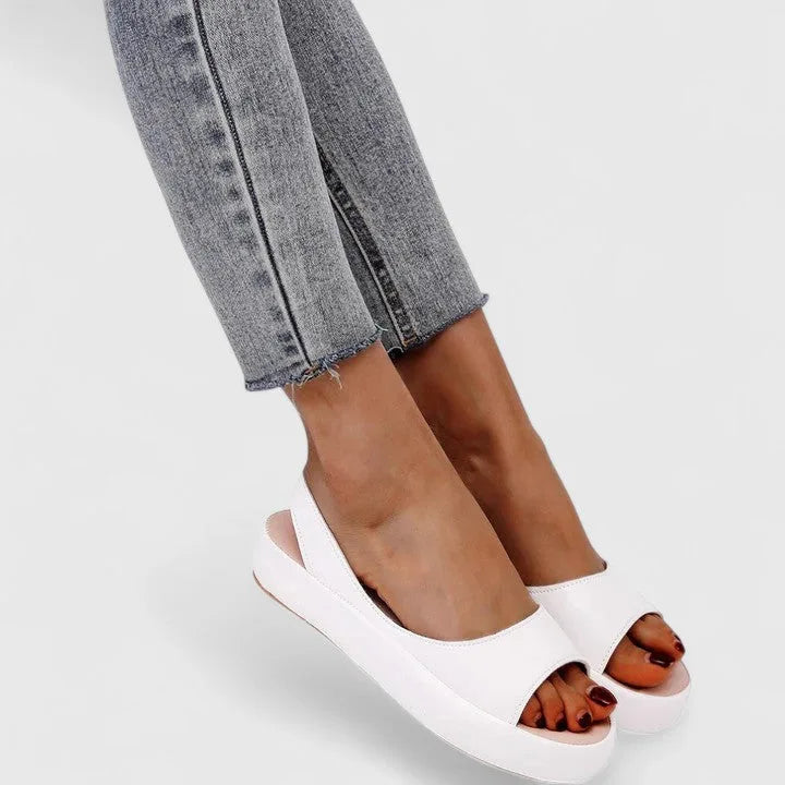 Close-up top view of pink platform sandals highlighting the soft leather-look upper and open toe