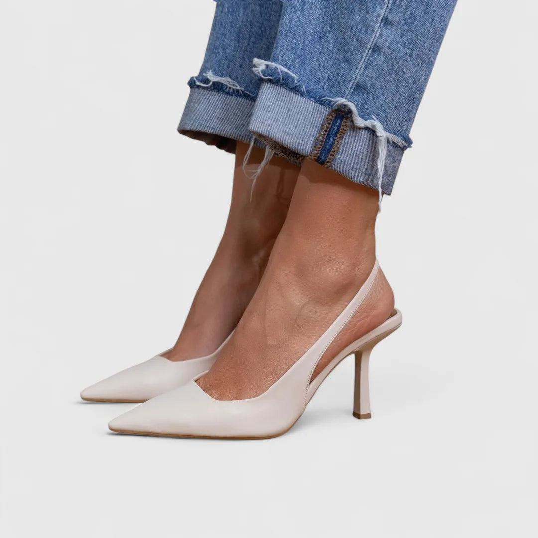Soft white leather slingback heels with pointed toe and slim covered heel, paired with cuffed denim