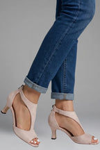 Side angle of pink cutout sandals showing the curved upper shape and slim mid heel