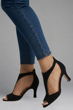 Side view of the same style in black suede, showing the cutout panel and peep toe design