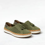 Pair of olive green suede slip-on sneakers shown from a three-quarter angle against a plain background, highlighting the stitched white and cork midsole