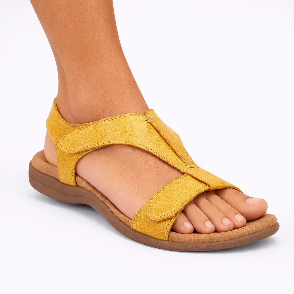 Mustard yellow T-strap sandal with contrast stitching and cushioned footbed, side angle view