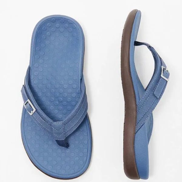 Top and side view of a denim-blue thong sandal with textured footbed and brown outsole
