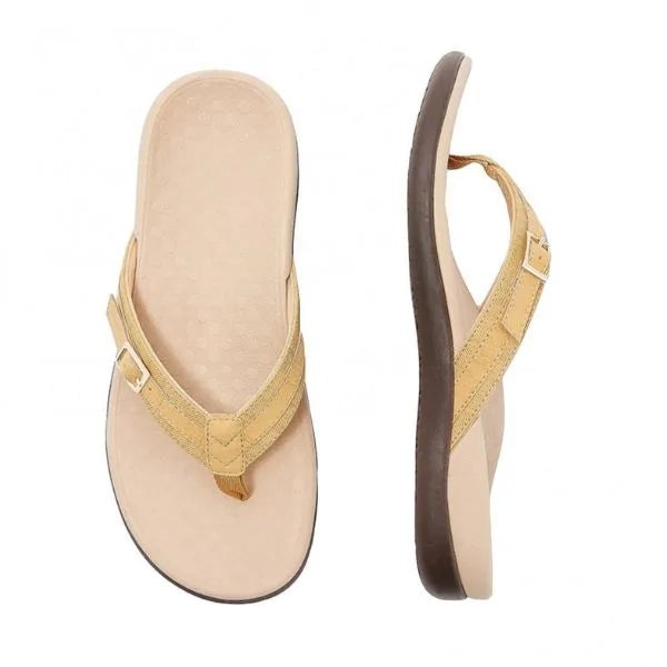 Top and side view of a mustard yellow thong sandal with stitched strap detail and tan cushioned footbed
