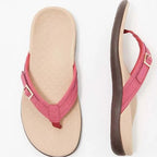Side profile of a thong sandal showing the contoured arch support footbed and layered brown sole
